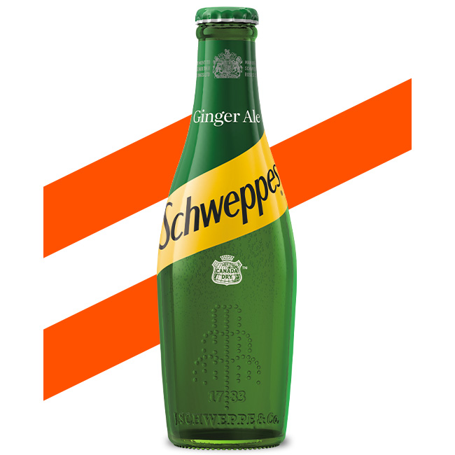 Schweppes Canada Dry Ginger Ale bottle on white background.