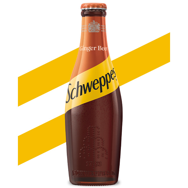 Schweppes Ginger Beer bottle on white background.