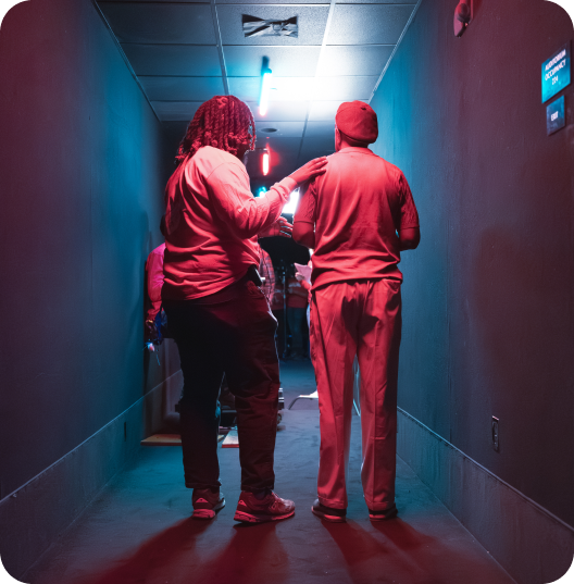 Crew members walking through neon-lit hallway on Cinemark film production